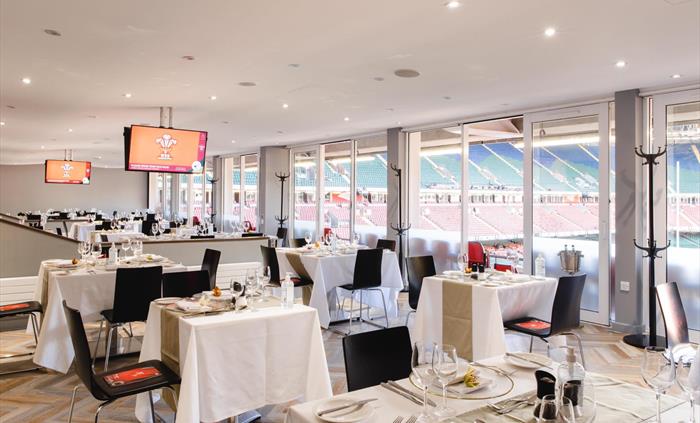 South Stand Lounge at Principality Stadium Cardiff overlooking the pitch, set up for a private event.